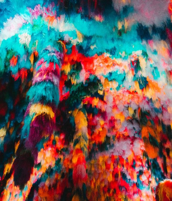 Woman in a dynamic cardio pose against a dark background.